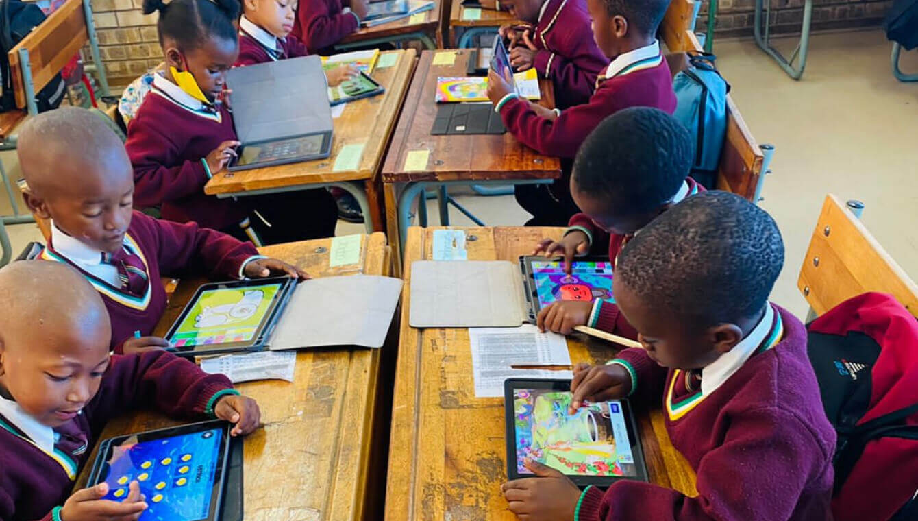 Children learning on iPads