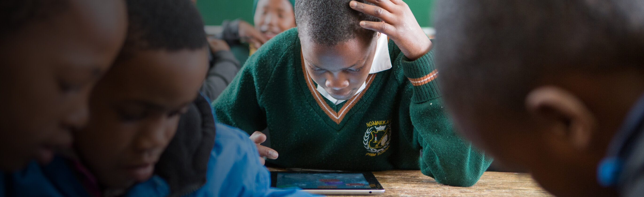 Children learning on an iPad