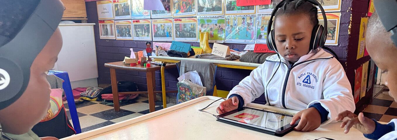 Child listening to a story on iPad